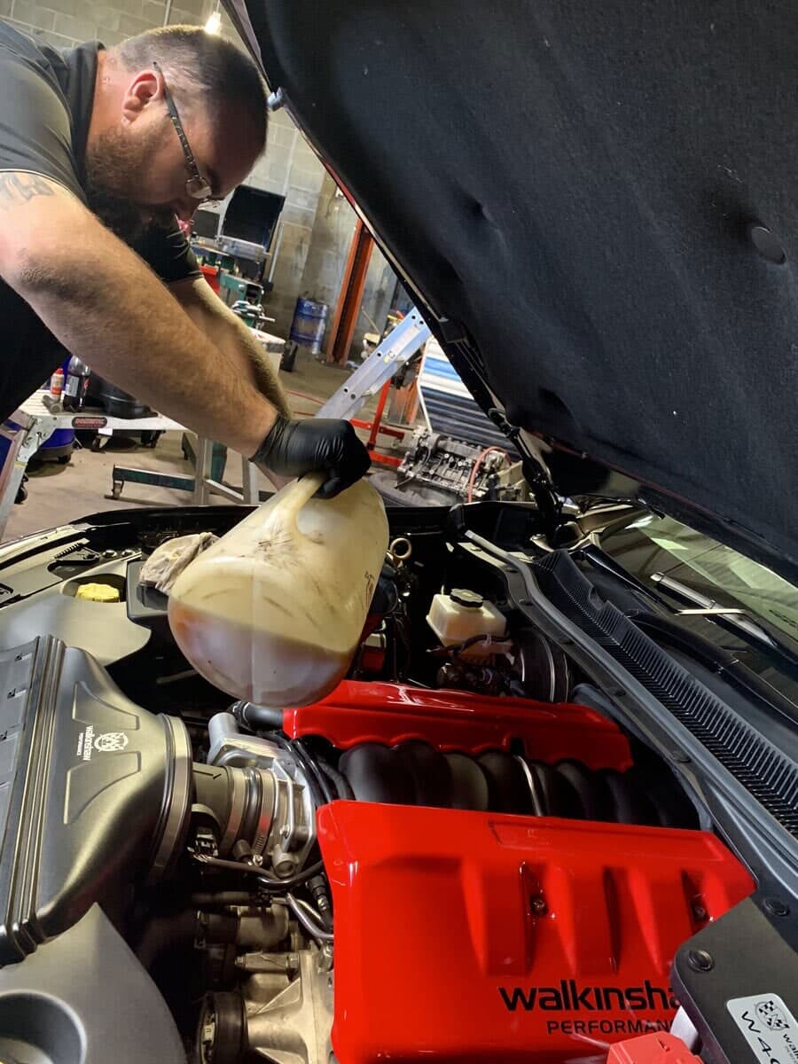 Joe's Auto Service Centre mechanic repairing a vehicle engine bay in Forster