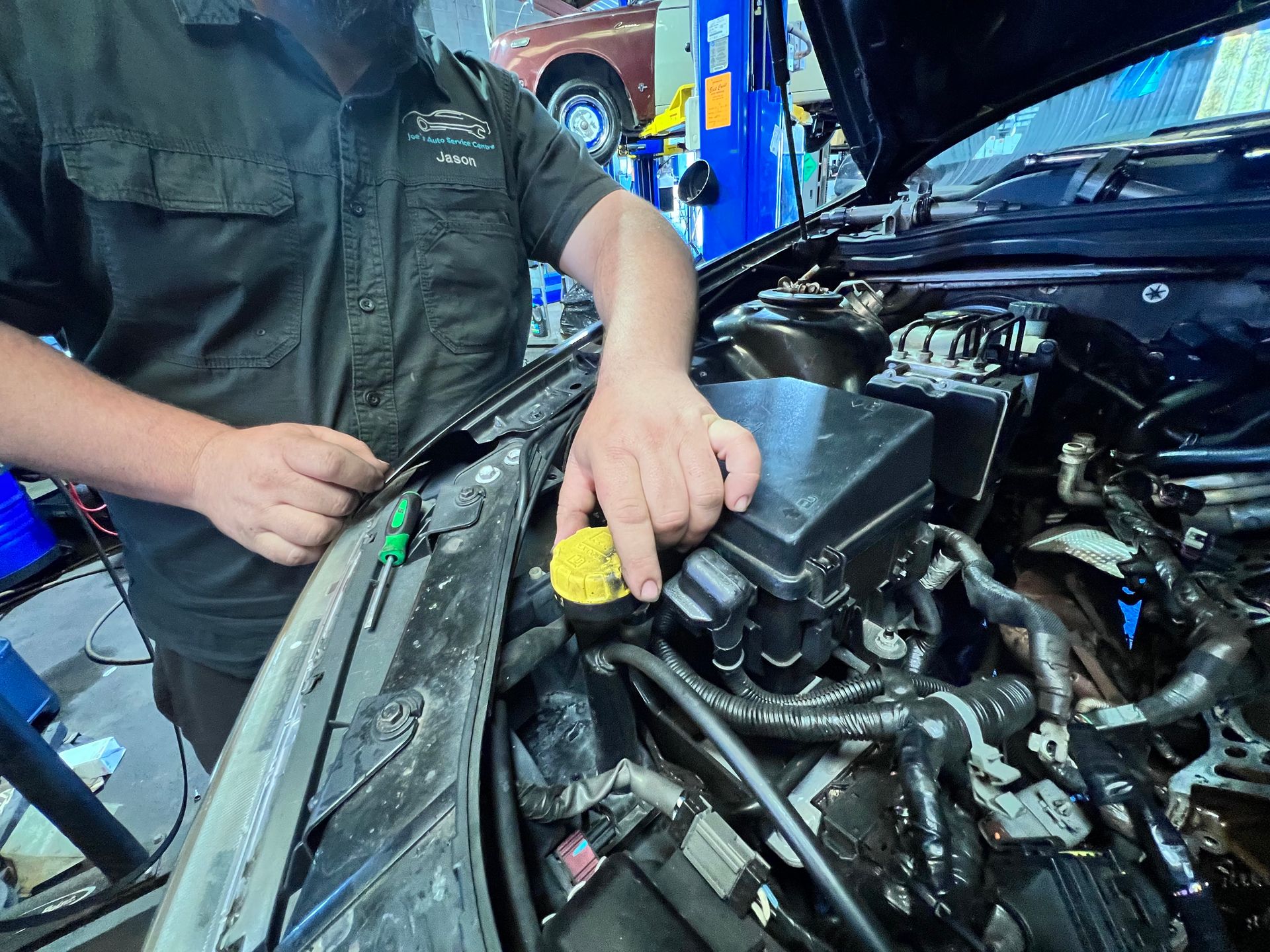 Mechanic working on a customer's vehicle at Joe's Auto Service Centre in Forster